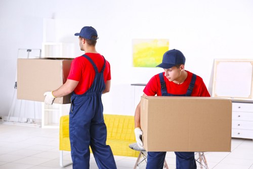 Furniture pick-up service removing a sofa in Hackney