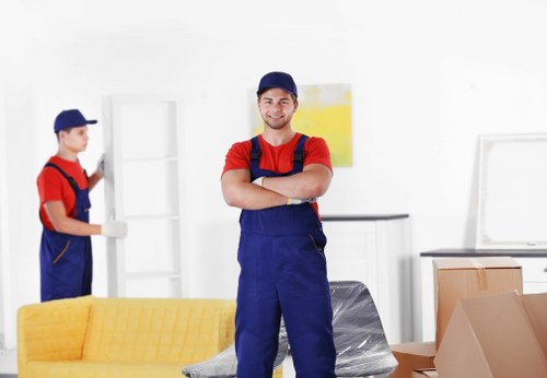Professional movers transporting belongings through a Hackney property