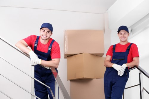 Staff using careful lifting methods during a house removal