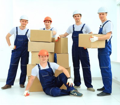 Packing boxes and furniture inside a Hackney flat during relocation