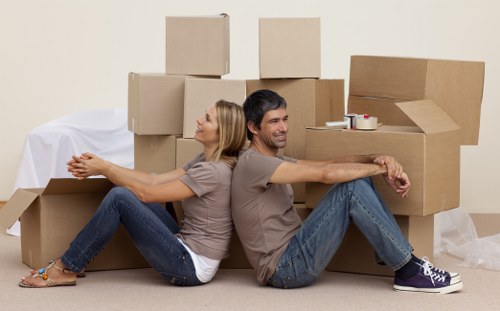 Removal staff handling boxes and furniture safely
