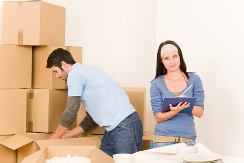 Removal team handling furniture in a Hackney street